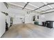 Spacious garage with ample storage cabinets, utility sink, and trash receptacle at 131 Wimbledon Cir, Lake Mary, FL 32746