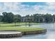 Picturesque view of the golf course and the water hazard with condominiums in the background at 131 Wimbledon Cir, Lake Mary, FL 32746