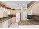 Well-lit kitchen featuring granite countertops, white cabinets, and stainless-steel appliances at 131 Wimbledon Cir, Lake Mary, FL 32746