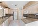 Traditional-style kitchen with granite countertops, light wood cabinets, and modern appliances at 131 Wimbledon Cir, Lake Mary, FL 32746