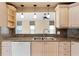 Kitchen sink with granite countertops, custom cabinets, and stainless-steel faucet at 131 Wimbledon Cir, Lake Mary, FL 32746