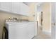 Bright laundry room featuring a white washer, dryer, and ample cabinet space at 131 Wimbledon Cir, Lake Mary, FL 32746