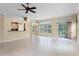 Open-concept living room with tile flooring, large windows, and views into the kitchen area at 131 Wimbledon Cir, Lake Mary, FL 32746