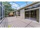 Spacious screened patio with a wood deck, perfect for enjoying outdoor living and slider entry at 131 Wimbledon Cir, Lake Mary, FL 32746