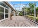 Large screened patio with wood deck, ideal for outdoor entertaining and relaxation at 131 Wimbledon Cir, Lake Mary, FL 32746