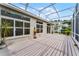 Large screened patio with wood deck, ideal for outdoor entertaining and relaxation at 131 Wimbledon Cir, Lake Mary, FL 32746
