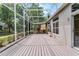 Spacious screened patio with a wood deck, perfect for enjoying outdoor living at 131 Wimbledon Cir, Lake Mary, FL 32746