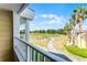 Relaxing balcony view overlooking lush golf course landscaping on a beautiful day at 1322 Seven Eagles Ct # 301, Reunion, FL 34747
