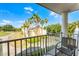 Balcony overlooking beautifully landscaped lawns, mature trees, and stunning architecture at 1322 Seven Eagles Ct # 301, Reunion, FL 34747
