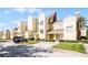 Beautiful building exterior with manicured landscaping, private entrances, and parking at 1322 Seven Eagles Ct # 301, Reunion, FL 34747