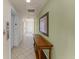 Well-maintained hallway with tiled flooring, elevator access, and classic decor at 1322 Seven Eagles Ct # 301, Reunion, FL 34747