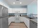 Bright kitchen featuring granite countertops, stainless steel appliances, and white cabinetry at 1322 Seven Eagles Ct # 301, Reunion, FL 34747