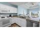 Bright kitchen boasts granite countertops, white cabinetry, and modern stainless steel appliances at 1322 Seven Eagles Ct # 301, Reunion, FL 34747