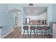 Open kitchen with white cabinetry, granite countertops, and bar seating area at 1322 Seven Eagles Ct # 301, Reunion, FL 34747