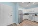Modern kitchen with stainless steel appliances, white cabinetry, and wood-style flooring at 1322 Seven Eagles Ct # 301, Reunion, FL 34747