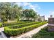 Neatly manicured hedges and landscaping enhance the exterior of the lovely tan townhomes at 1322 Seven Eagles Ct # 301, Reunion, FL 34747