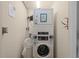 Convenient laundry area featuring stacked washer and dryer, maximizing space and efficiency at 1322 Seven Eagles Ct # 301, Reunion, FL 34747