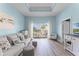 Cozy living room with tray ceilings, wood floors, and bright natural light at 1322 Seven Eagles Ct # 301, Reunion, FL 34747