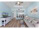 Cozy living room with adjacent kitchen, comfortable seating, and bright, airy ambiance at 1322 Seven Eagles Ct # 301, Reunion, FL 34747