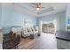 Comfortable living room with stylish furniture, wood floors, tray ceilings, and lots of light at 1322 Seven Eagles Ct # 301, Reunion, FL 34747