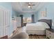 Inviting bedroom with tray ceilings, wood floors, and ample natural light at 1322 Seven Eagles Ct # 301, Reunion, FL 34747