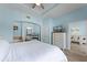 Bright main bedroom with tray ceiling, ensuite bath, and view of the living room at 1322 Seven Eagles Ct # 301, Reunion, FL 34747