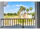 Balcony view of a tan home, landscaping and golf course at 1322 Seven Eagles Ct # 301, Reunion, FL 34747