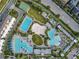 Aerial view of a community featuring multiple pools, a playground, and meticulously kept landscaping at 13241 Cormack Ln, Orlando, FL 32827