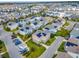Neighborhood aerial view showcasing homes with solar panels, street layout and parking at 13241 Cormack Ln, Orlando, FL 32827