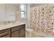 Well-lit bathroom with a floral shower curtain, modern vanity, and clean design promotes a refreshing and relaxing atmosphere at 13241 Cormack Ln, Orlando, FL 32827