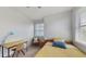 Bright bedroom features a cozy bed, ample natural light, simple desk, and a tranquil setting for study or relaxation at 13241 Cormack Ln, Orlando, FL 32827