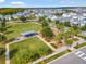 Community park featuring a large grassy field, covered picnic area, landscaping, and walking paths at 13241 Cormack Ln, Orlando, FL 32827