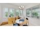 Bright dining area with a modern table set and large windows offering a pleasant view at 13241 Cormack Ln, Orlando, FL 32827