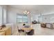 Cozy dining area with a round table, modern lighting, and large windows at 13241 Cormack Ln, Orlando, FL 32827