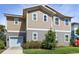 Two-story home featuring a landscaped yard with lush green grass and mature trees at 13241 Cormack Ln, Orlando, FL 32827