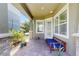 Inviting front porch features a comfortable bench, stone accents, and lush landscaping, creating a welcoming entry at 13241 Cormack Ln, Orlando, FL 32827