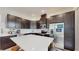 Modern kitchen features a central island with sleek white countertop and dark cabinetry, stainless steel appliances, and recessed lighting at 13241 Cormack Ln, Orlando, FL 32827