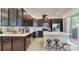 Stylish kitchen featuring dark cabinets, stainless steel appliances, and a large island with seating at 13241 Cormack Ln, Orlando, FL 32827