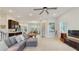 Bright living room with a ceiling fan, wood flooring, and an open floor plan at 13241 Cormack Ln, Orlando, FL 32827