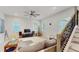 Open-concept living room featuring wood floors, a ceiling fan, and lots of natural light at 13241 Cormack Ln, Orlando, FL 32827