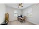 Bright home office includes a ceiling fan, well-lit workspace with modern desk, comfortable chair, and ample natural light at 13241 Cormack Ln, Orlando, FL 32827