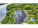 Aerial view of boat docks on the river and community pool near lush green trees at 133 Moss Dr, Debary, FL 32713