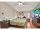 Inviting bedroom with warm wood floors and a cozy chair near a window with natural light at 133 Moss Dr, Debary, FL 32713