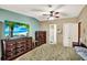 Comfortable bedroom with ample storage, a ceiling fan, and a mounted TV at 133 Moss Dr, Debary, FL 32713