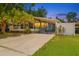 Charming home exterior featuring a gated drive, lush lawn, and mature trees at 133 Moss Dr, Debary, FL 32713