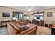 Inviting living room with leather seating, a ceiling fan, and a view to the outside at 133 Moss Dr, Debary, FL 32713