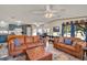Warm living space with a plush sofa, an area rug, and a view into the dining area and kitchen at 133 Moss Dr, Debary, FL 32713
