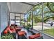 Inviting screened porch featuring comfortable seating and a view of the neighborhood street at 133 Moss Dr, Debary, FL 32713