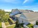 Beautiful aerial view of a lakeside home with a covered patio, lush landscaping, and a paved driveway at 13618 Briand Ave, Orlando, FL 32827