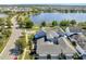 Aerial view showcasing a community near a lake with beautiful homes and well-maintained landscaping at 13618 Briand Ave, Orlando, FL 32827